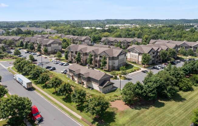 an aerial view of a large apartment complex with a red truck parked in front of it