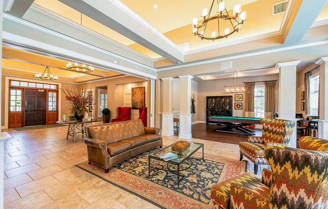 a living room with couches and a pool table