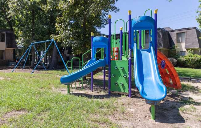 a playground with a slide and other toys in a yard