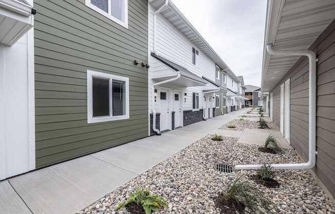 A row of houses with a gravel area in the foreground.