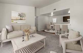 A living room with a couch, chairs, and a coffee table.