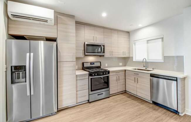 a kitchen with stainless steel appliances and a refrigerator