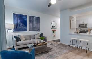 a living room with a couch coffee table and stools