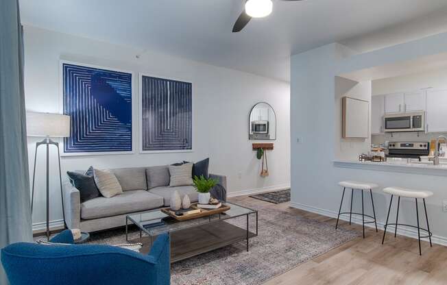 a living room with a couch coffee table and stools