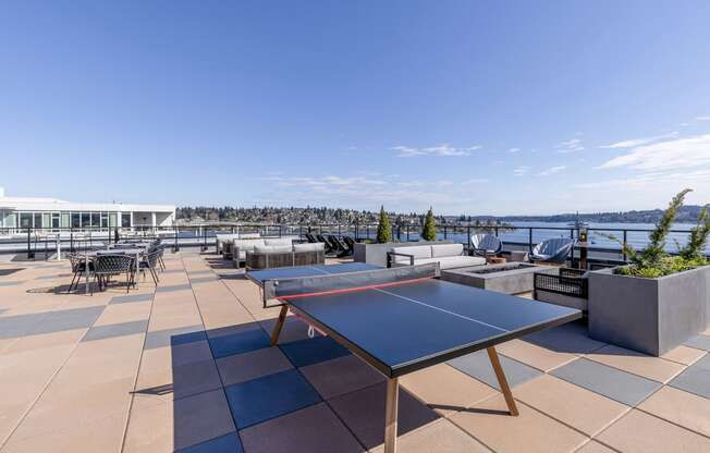 a terrace with a ping pong table and a view of the water at Marina Square, Bremerton, 98337