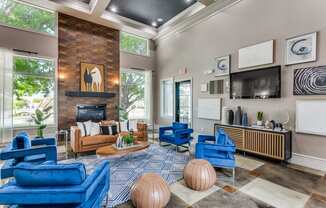 the preserve at ballantyne commons living room with blue chairs and a fireplace