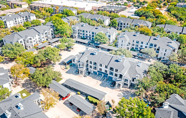 A bird's eye view of a residential area with houses and trees.