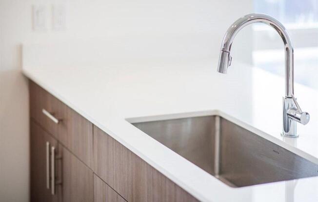 quartz island with stainless sink fixture