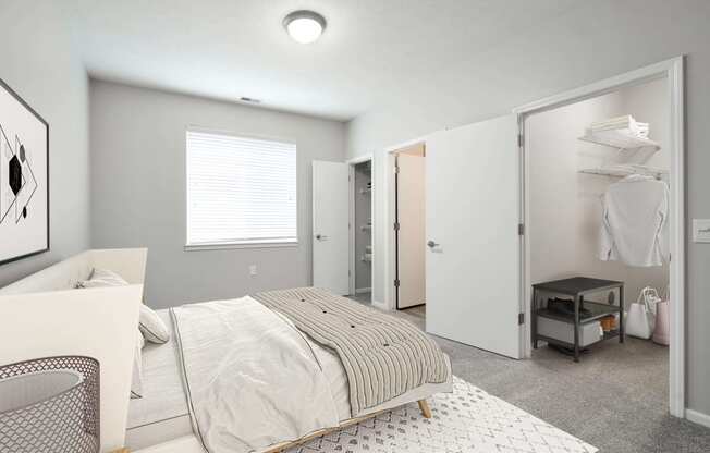 Spacious bedroom with a large window and plenty of space in the walk in closet.