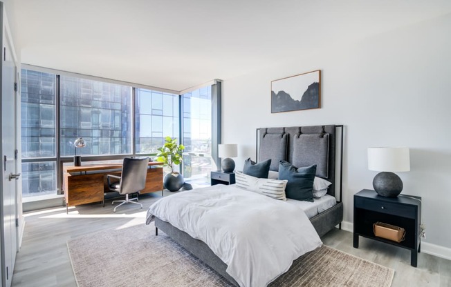 a bedroom with a bed and a large window