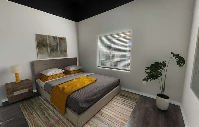 A bedroom with a bed, a lamp, a plant, and a painting on the wall.