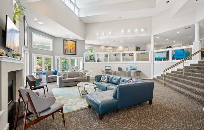 A living room with a fireplace and a blue couch.