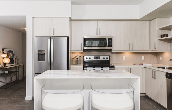 Kitchens with custom cabinetry, bar seating, and built-in shelves