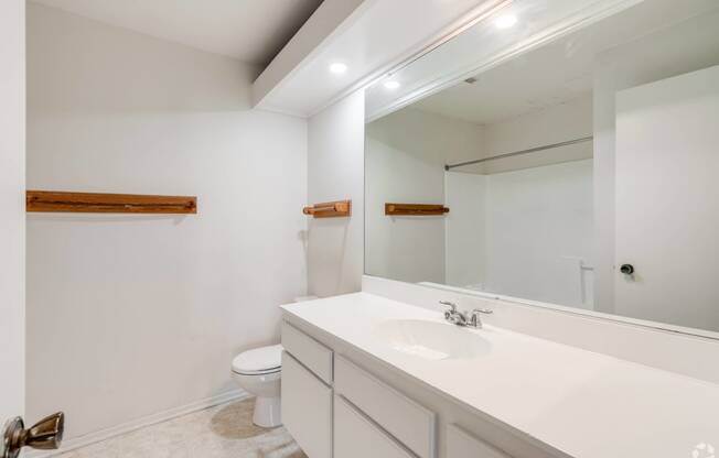 a bathroom with a large mirror and a sink and a toilet at Alosta Place, Azusa, 91702