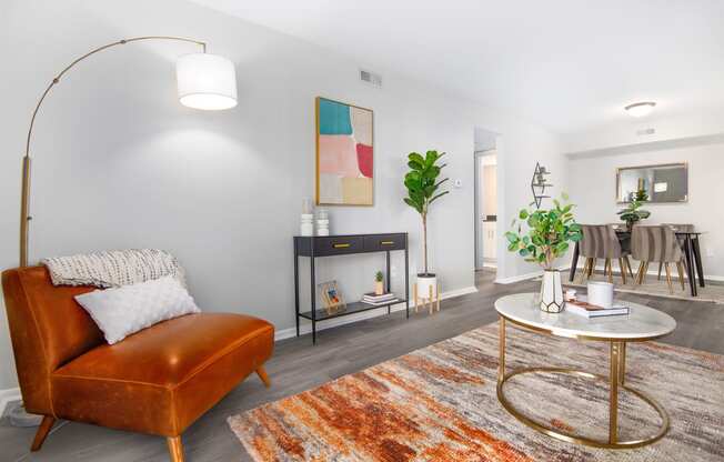 a living room with a leather couch and a round table