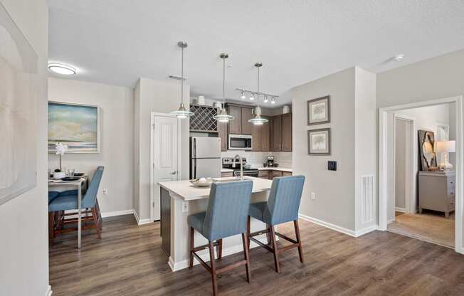 a kitchen and dining room with a table and chairs