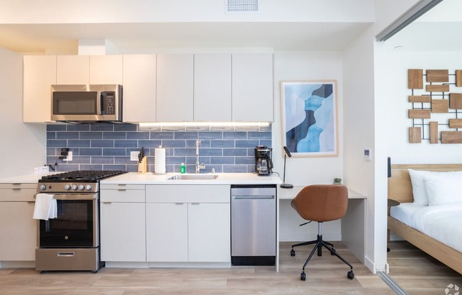 a kitchenette and a bed in a 555 waverly unit
