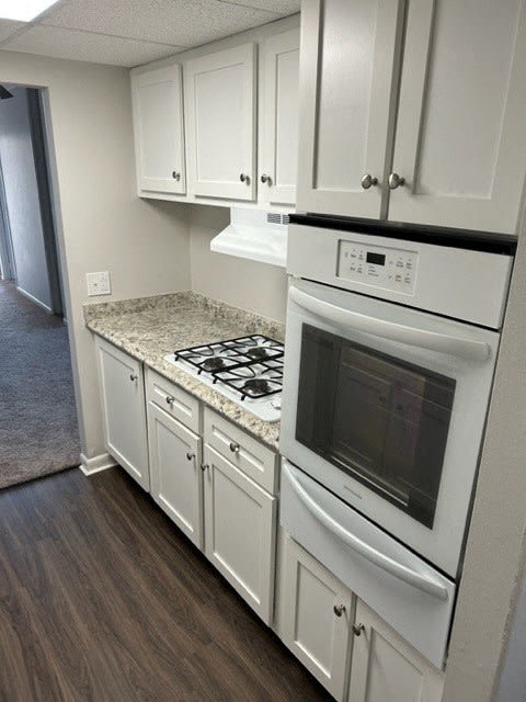 White kitchen cabinets with luxury vinyl planking