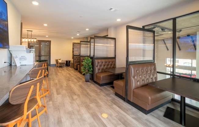 a seating area in a restaurant with chairs and tables
