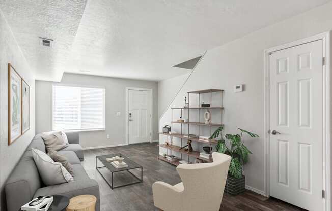 Model living room with a grey couch and a coffee table