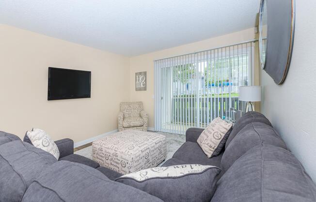 a living room filled with furniture and a flat screen tv