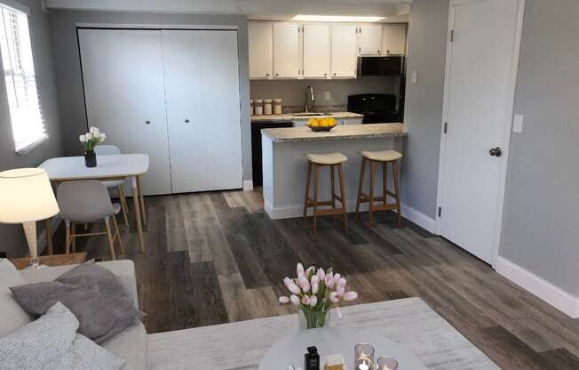 a living room and kitchen with a table and chairs