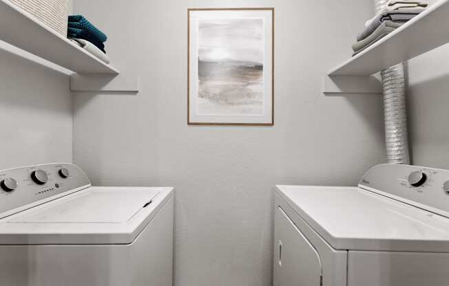 a laundry room with a washer and dryer and a painting on the wall at Verona, Littleton, CO, 80123