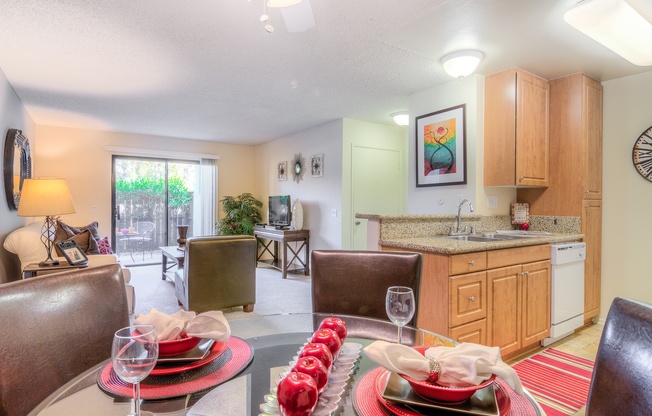 A dining room with a table set for a meal.