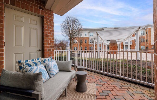 a patio with a couch and a door to a building