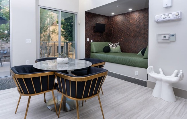 A modern dining room with a glass table and chairs.