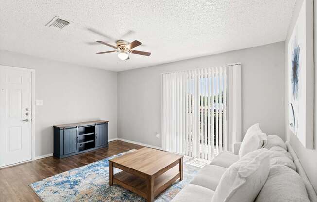 A living room with a wooden coffee table and a white couch.