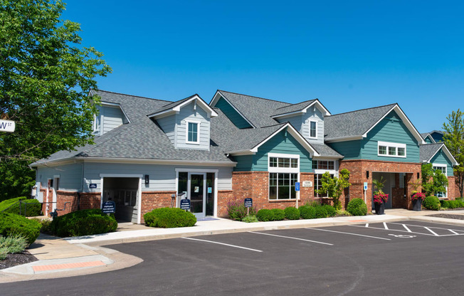 a large house with a parking lot in front of it
