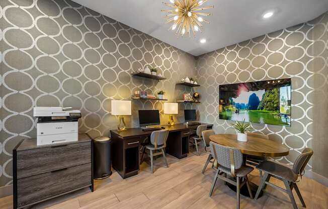 A modern home office with a patterned wallpaper and a wooden desk.
