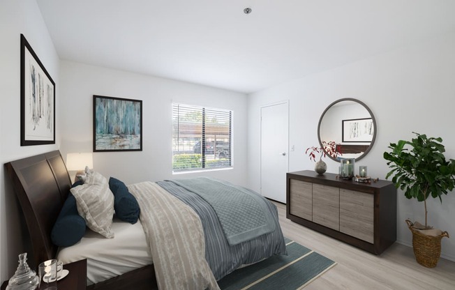 a bedroom with a bed and dresser in a 555 waverly unit