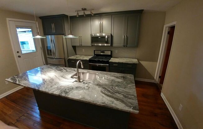 Beautifully renovated gem in South Side. Granite, Stainless, Hardwood Floors, Laundry A/C