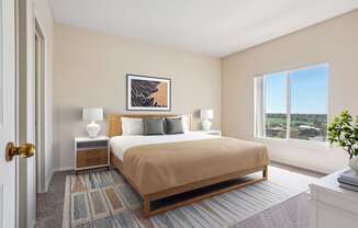 A bedroom with a bed, nightstands, and a window overlooking a landscape.