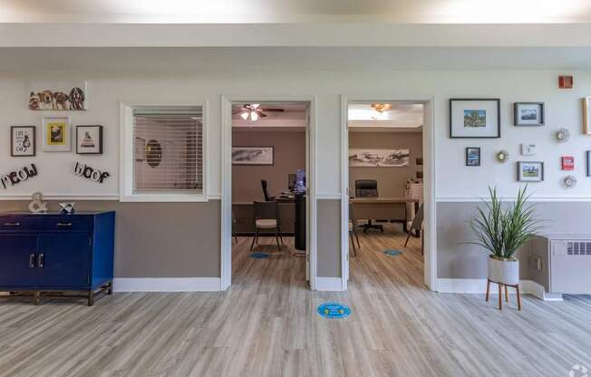 A room with a blue cabinet and a white fridge.