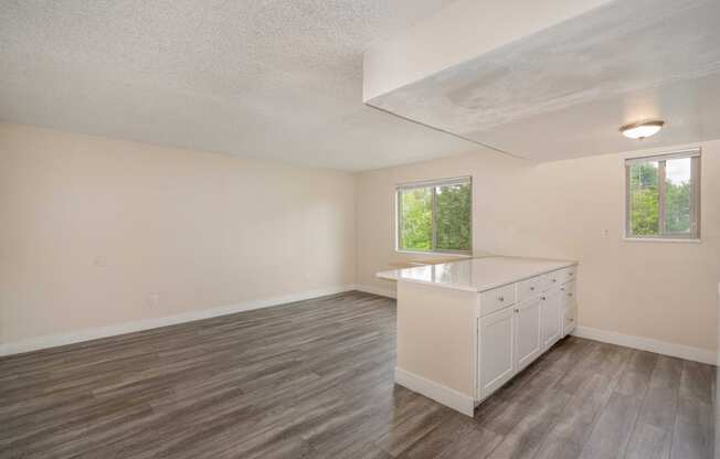 a rendering of a room with a row of white cabinets and a ceiling with a