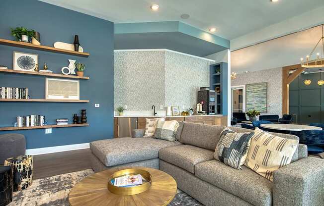 A living room with a grey couch and a wooden coffee table.
