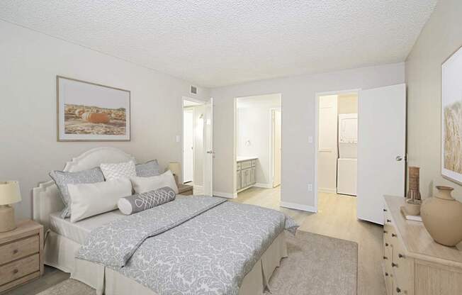 A bedroom with a large bed and a painting on the wall.