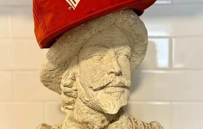 a statue of a baseball player with a hat on it at The Teale Navy Yard, North Charleston, 29405