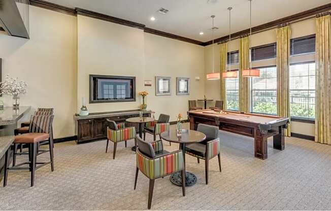 a resident clubhouse with a pool table and dining area