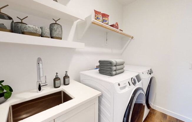 a small laundry room with a washing machine and sink