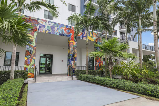 One of the entrances to our community with mural designs and palm trees at Bay Village 1 in Palmetto Bay, FL