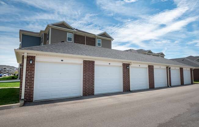 A row of garages with white doors at Mosaic Apartments in Avon, Indiana