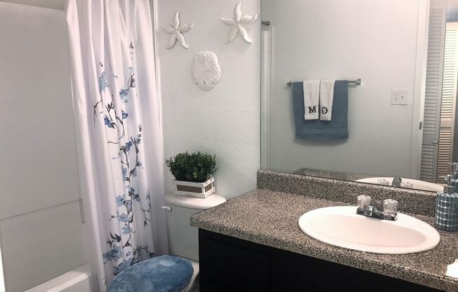 a bathroom with a sink toilet and bathtub