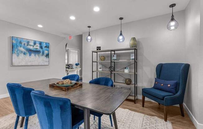 a dining room with blue chairs and a table