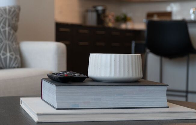 a book with a remote control and a bowl on top of it