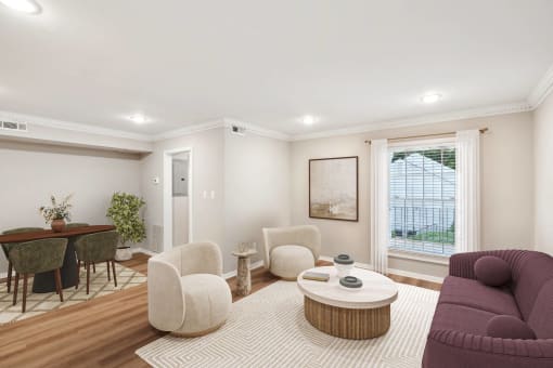 a living room with a couch and chairs and a table