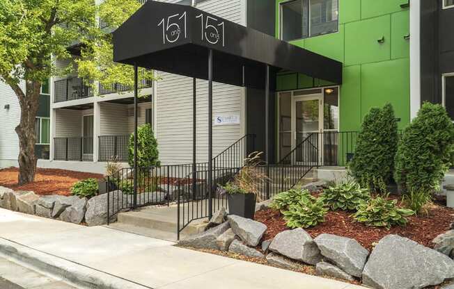 apartment entrance with a black awning that reads "151 on 8"